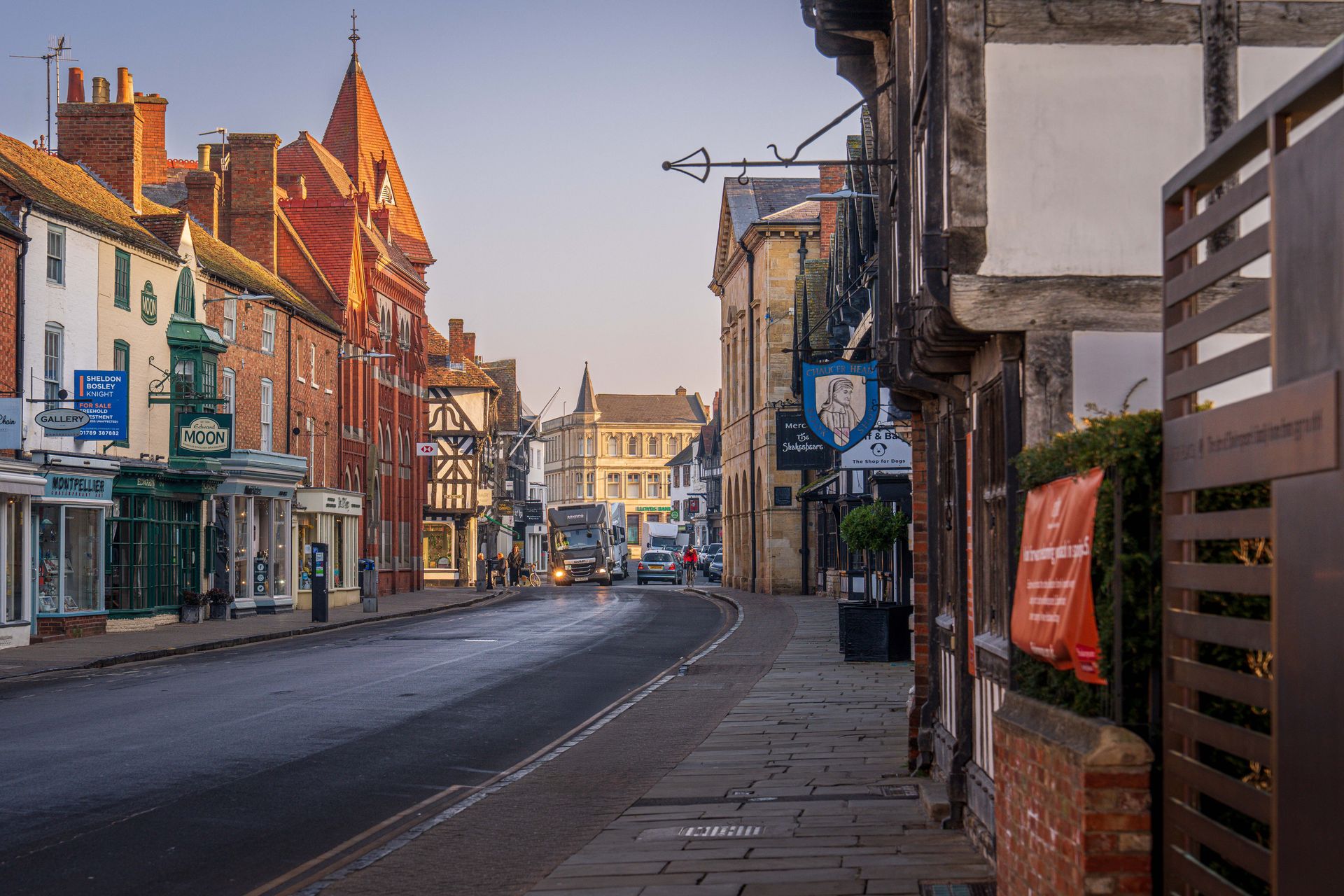 A picture of street scene in Stratford-upon-Avon, England showcasing charming architecture at dusk.